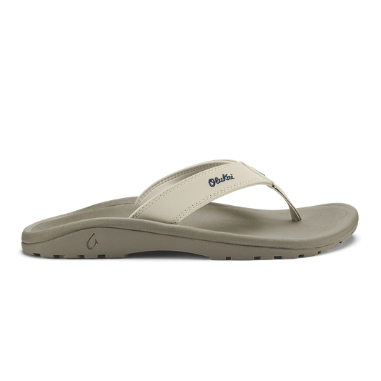 Cream and gray thong sandal with embroidered logo on upper strap and textured sole.
