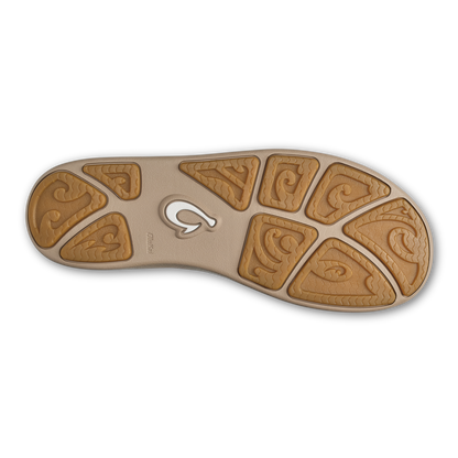 Tan rubber sole with geometric carved pattern and central logo on beige cushioned footbed.