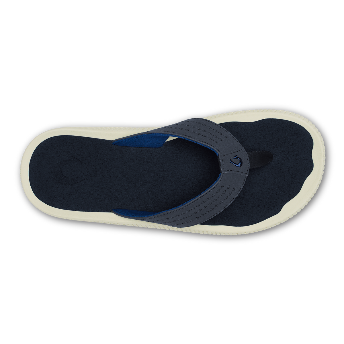 Navy and cream flip-flop sandal with perforated upper strap and dark fabric footbed, viewed from above.