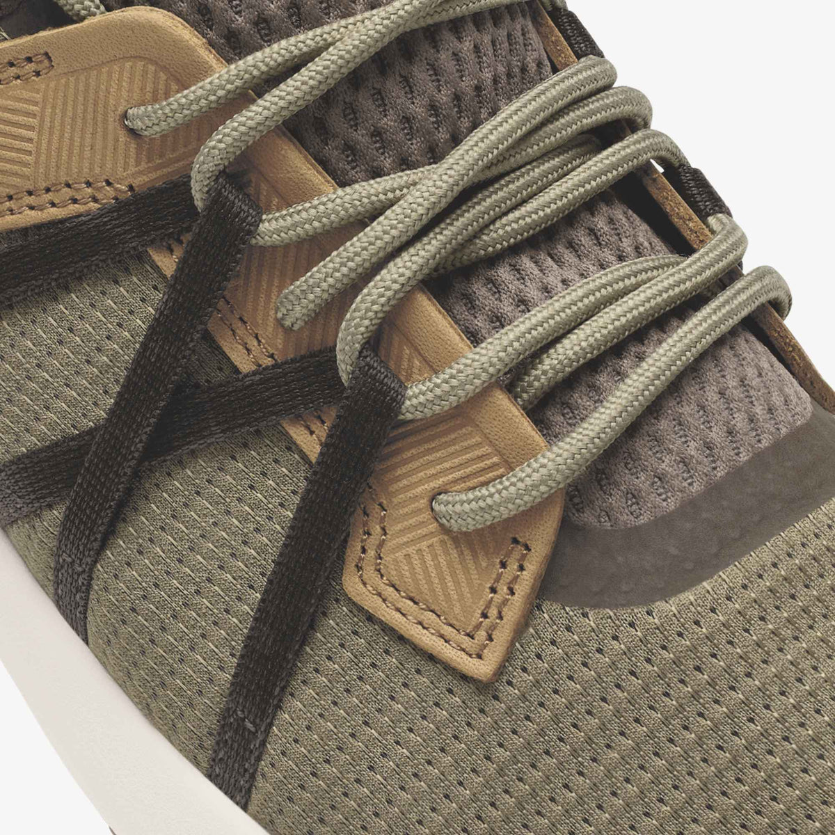Hiking shoe with tan leather trim, dark brown fabric upper, tan laces, and visible stitching detail.