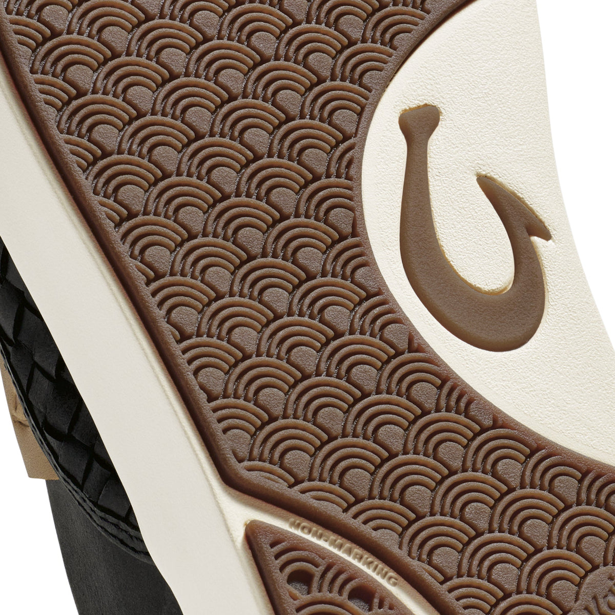 Brown and cream leather sandal with scalloped pattern design and hook closure detail, black sole visible.