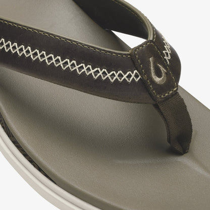 Gray and dark thong sandal with contrasting stitching detail and foam footbed.