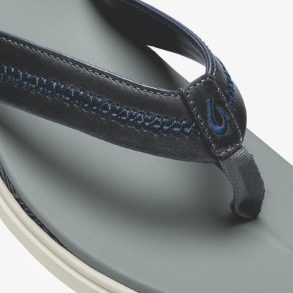 Pale grey thong sandal with dark navy leather strap and blue stitching detail on upper surface.