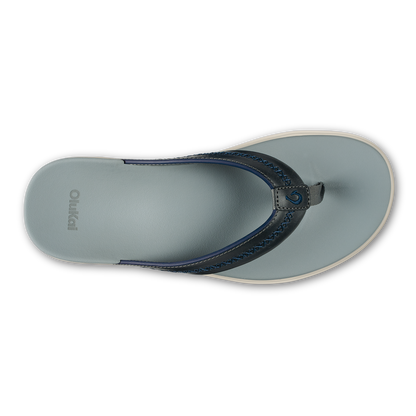 Pale grey flip-flop with dark blue leather thong strap and cream-colored sole, viewed from above.
