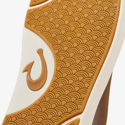 Tan and cream sneaker sole with geometric wave pattern and curved logo detail.