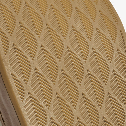 Tan clay textile with raised geometric chevron and linear pattern detail.