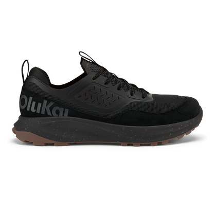 Black lace-up trail running shoe with mesh and suede upper, speckled midsole, and tan rubber outsole.