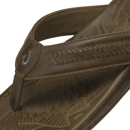 Tan leather thong sandal with geometric pattern footbed and stitched toe post detail.