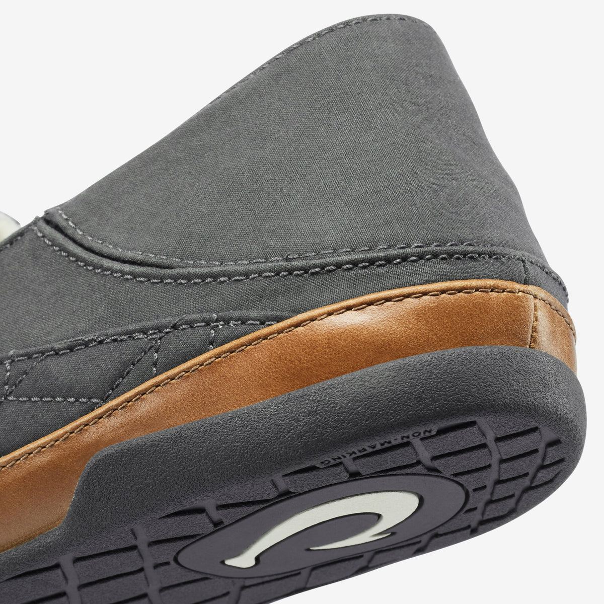 Dark gray canvas loafer with tan leather trim and dark rubber sole detail.
