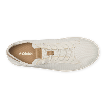 White canvas high-top sneaker with lace-up closure and tan heel tab, displayed from above.