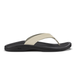 Ecru and black thong sandal with curved black sole and cushioned footbed.
