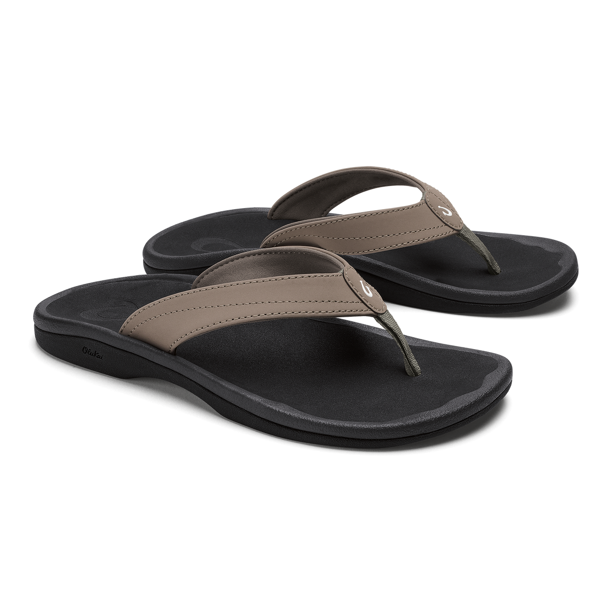 Pair of thong sandals with warm taupe straps and black cushioned footbeds.