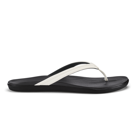 Black flip-flop sandal with bright white thong strap and cushioned footbed.