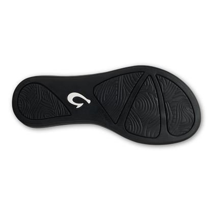 Black rubber shoe sole with textured tread pattern and white brand logo on heel.