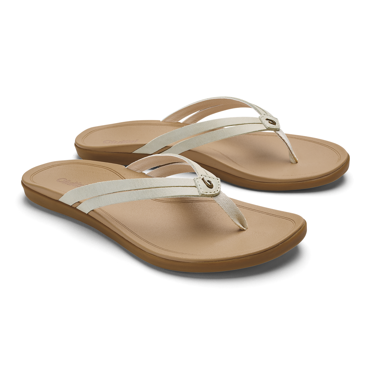 Pair of tan and cream flip-flop sandals with thong straps and cushioned footbeds.