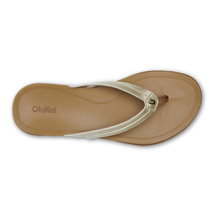 Tan thong sandal with metallic gold strap and adjustable buckle detail, viewed from above.