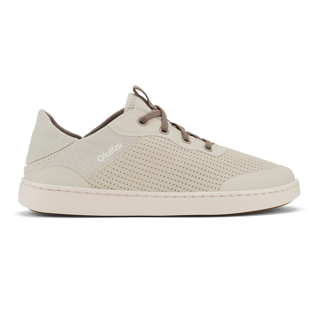 Cream-colored low-top sneaker with perforated mesh upper, brown laces, and cream rubber sole.