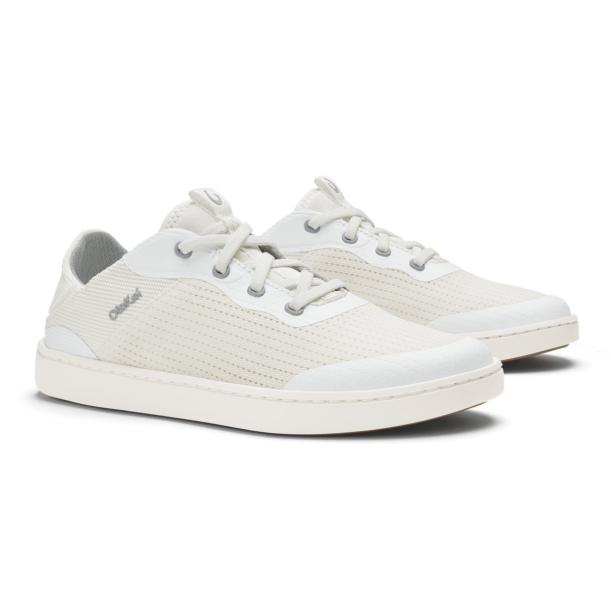 Bright white lace-up sneaker with textured upper, white sole, and gray heel tab.