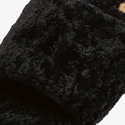 Black textured fabric with quilted pattern and gathered construction detail.