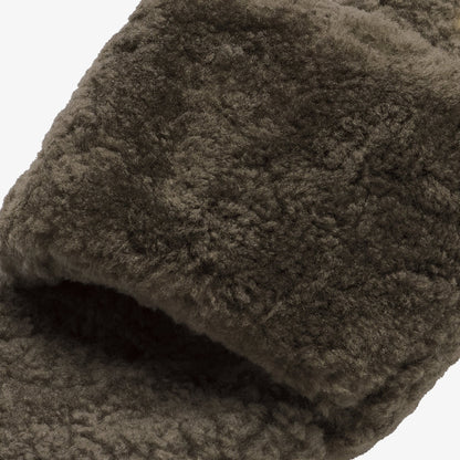 Walnut-colored textured fabric with plush pile shown folded to display depth and surface detail.