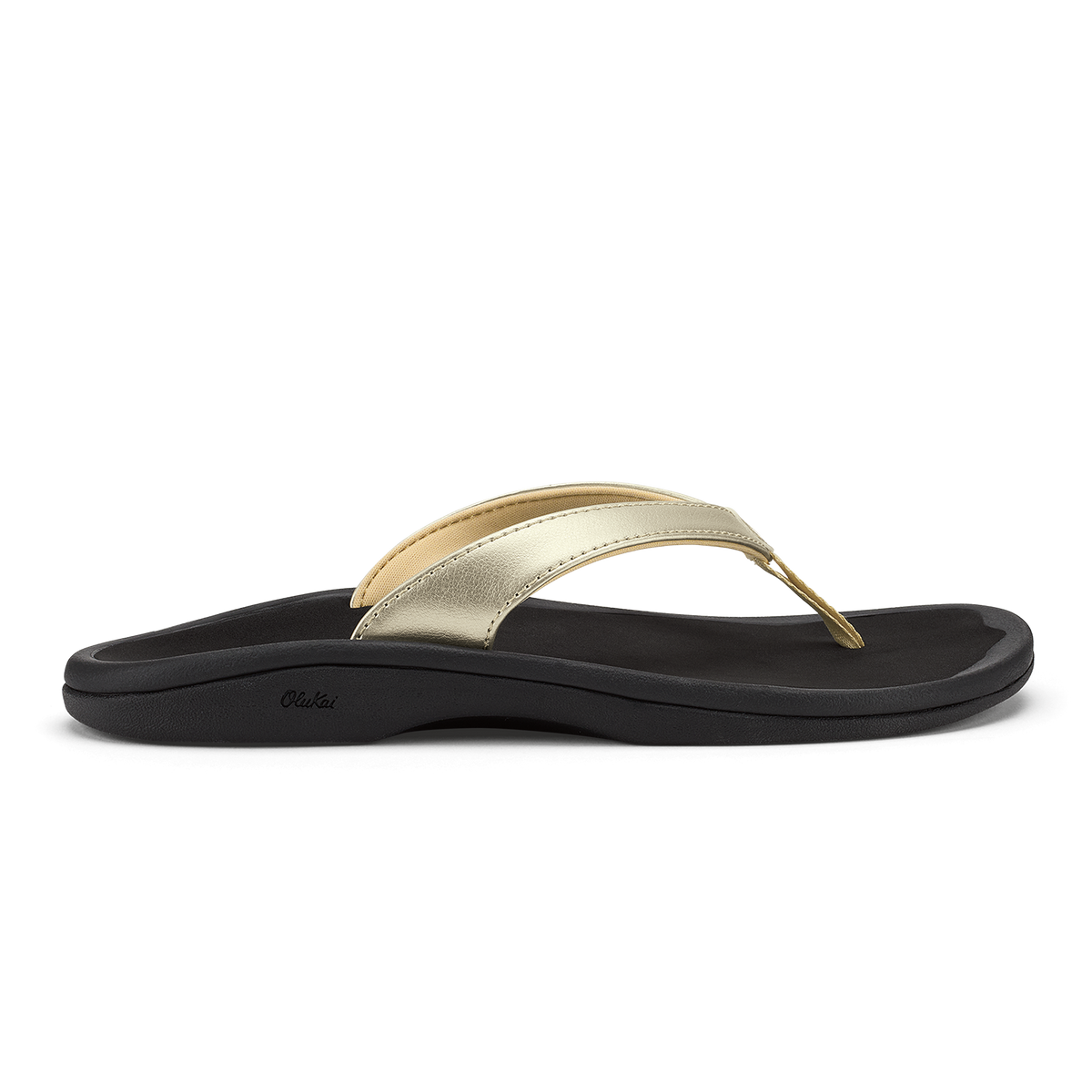 Gold metallic thong strap sandal with black cushioned sole and curved footbed.